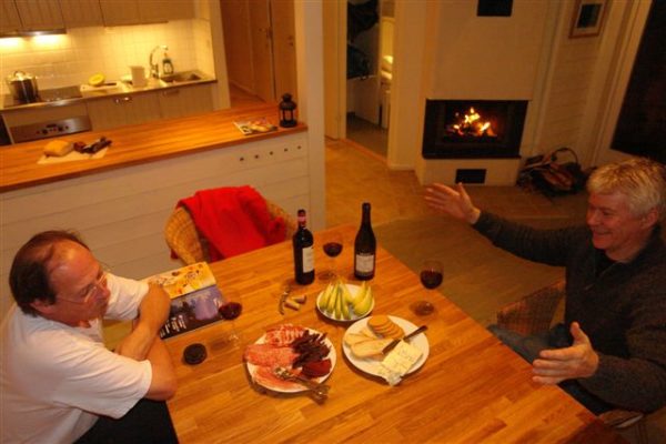 two men talking while eating