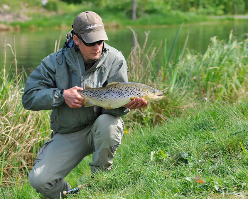 A person holding a fish