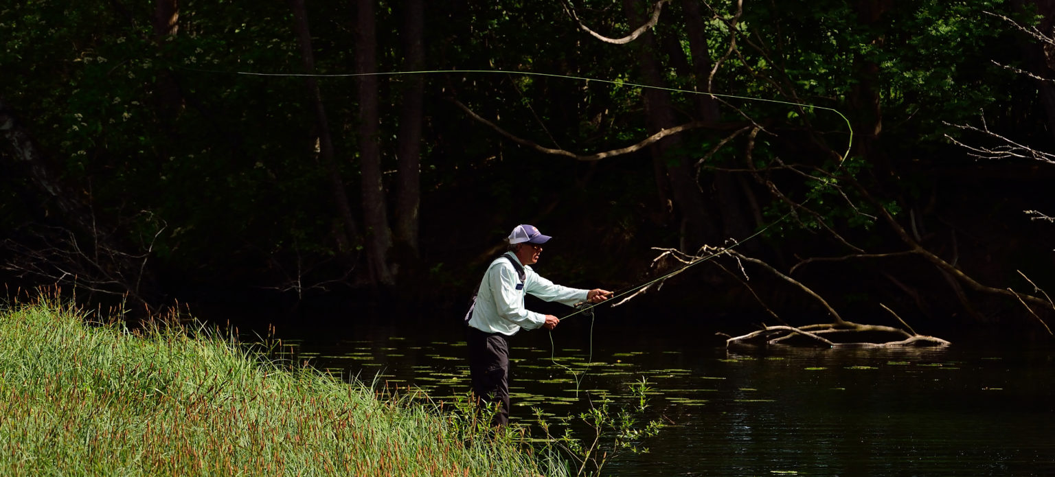 A person throwing the fishing line